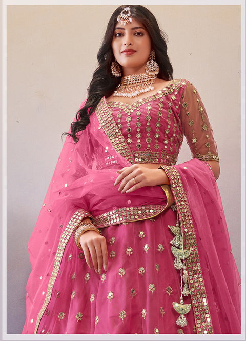 Exceptional Drak Pink Colored Partywear Embroidered Net Lehenga Choli